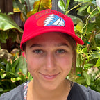 Red Baja Haha baseball cap with Grateful Dead logo on model.