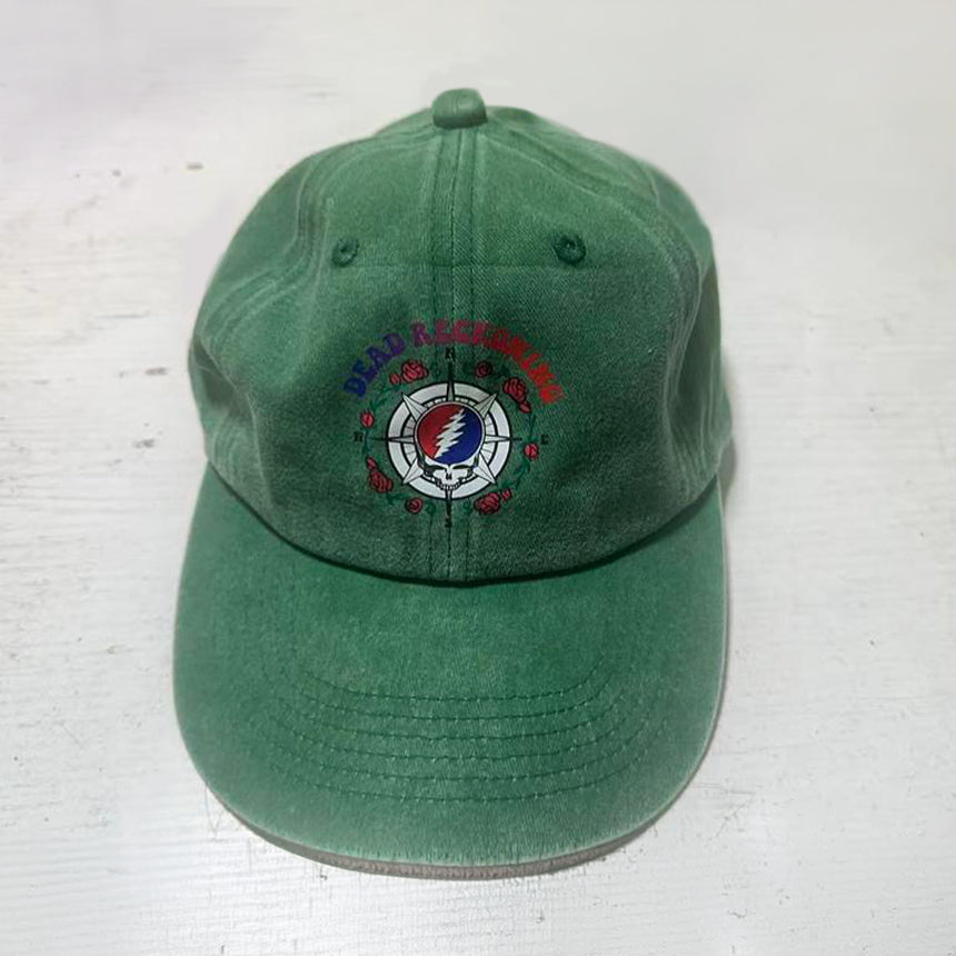 Green hat with the Dead Reckoning, Baja Haha logo of a compass with a skull and roses.