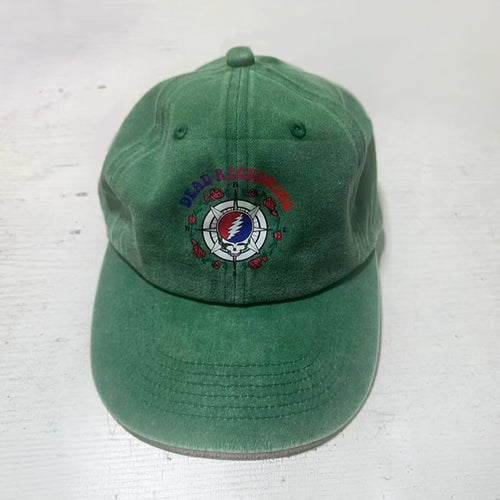 Green hat with the Dead Reckoning, Baja Haha logo of a compass with a skull and roses.