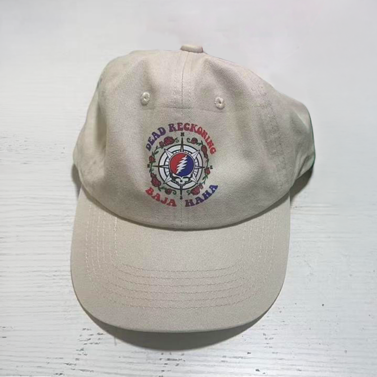 Tan hat with the Dead Reckoning, Baja Haha logo of a compass with a skull and roses.