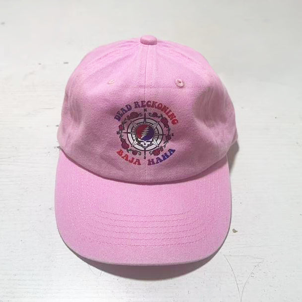 Pink hat with the Dead Reckoning, Baja Haha logo of a compass with a skull and roses.