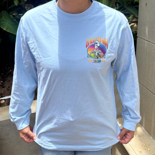The front of a grey shirt with a skeleton captain and the words Baja Haha 2026 on the front left. There is a sunset background to the skeleton.
